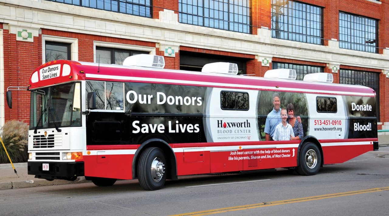 A red and white Hoxworth donor bus parked in Downtown Cincinnati