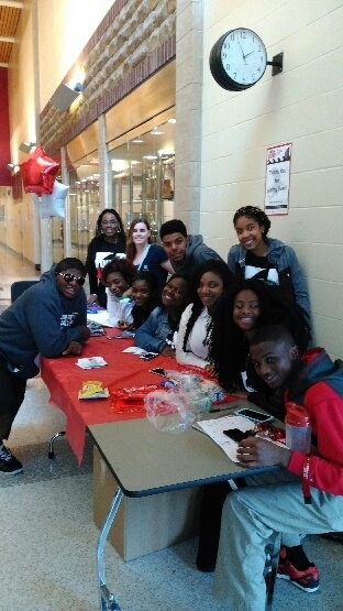 Group of young high school students at a Hoxworth registration table