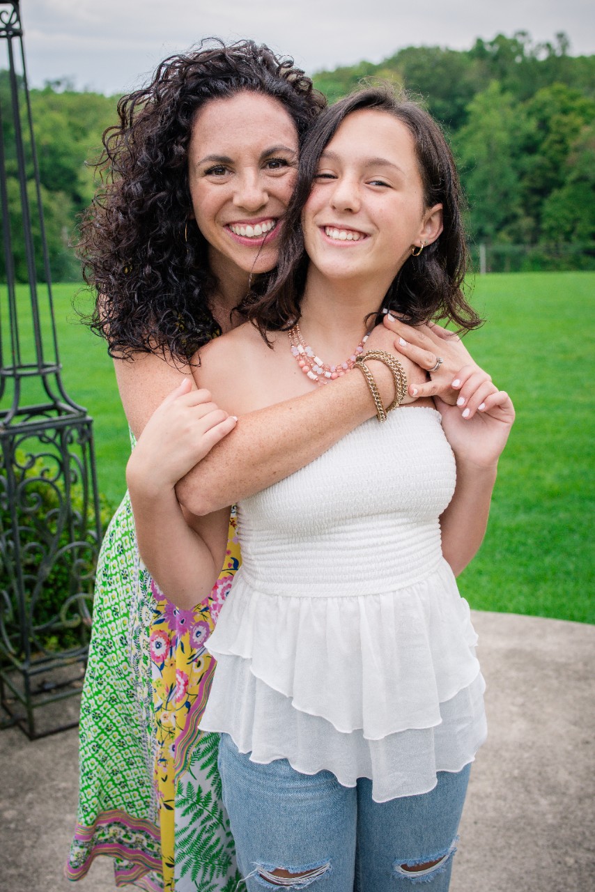 Leora and her mother Brett posing for a photo