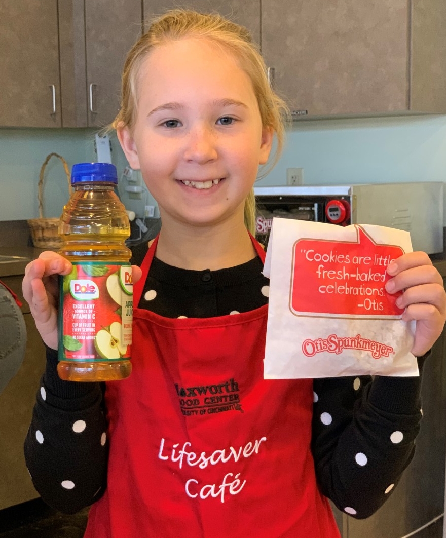 Livi holding up juice and cookies